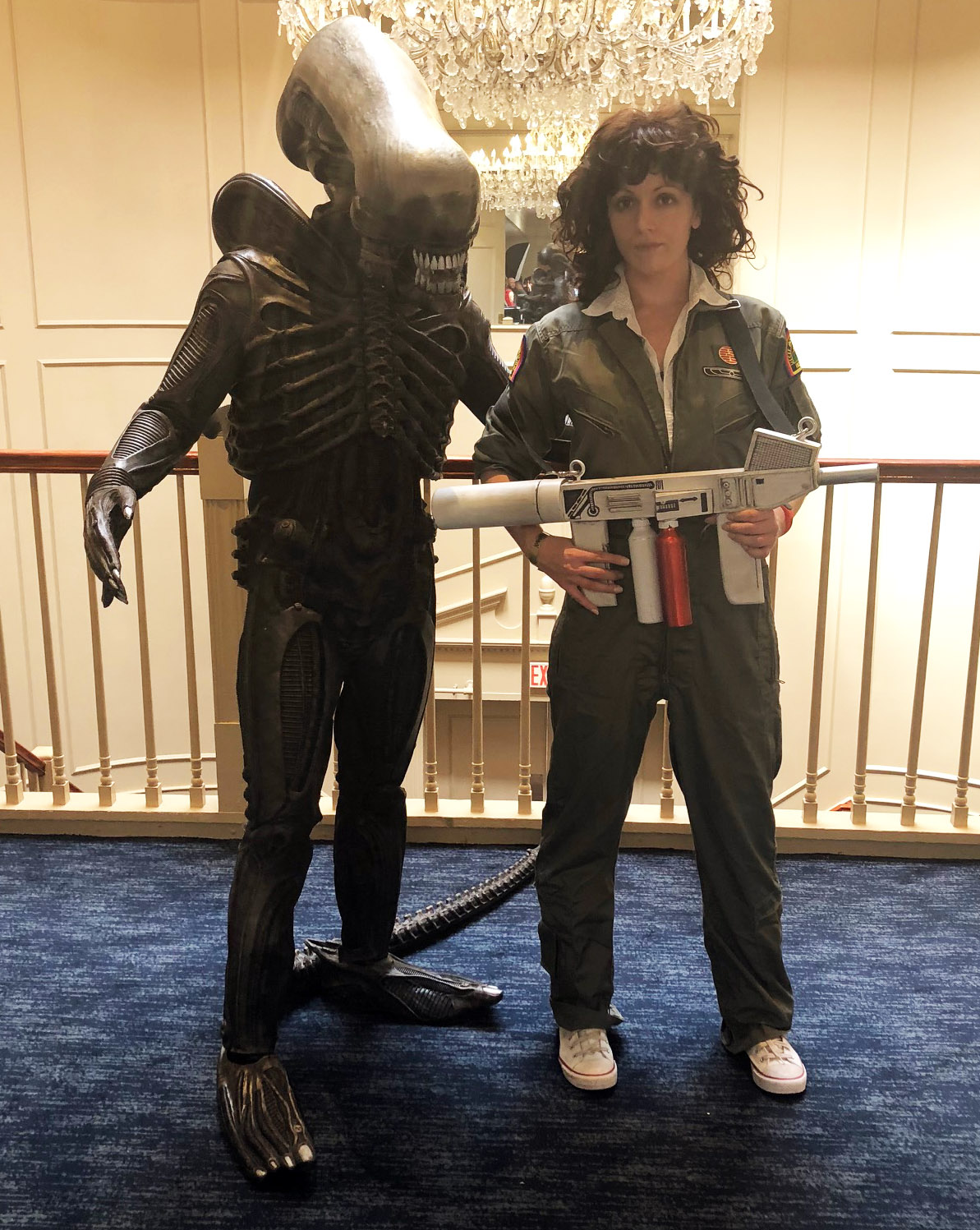 Two people dressed as a xenomorph and Ripley from the movie "Alien"